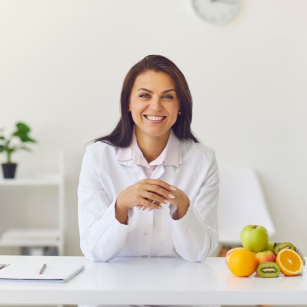 medical professional smiling at desk